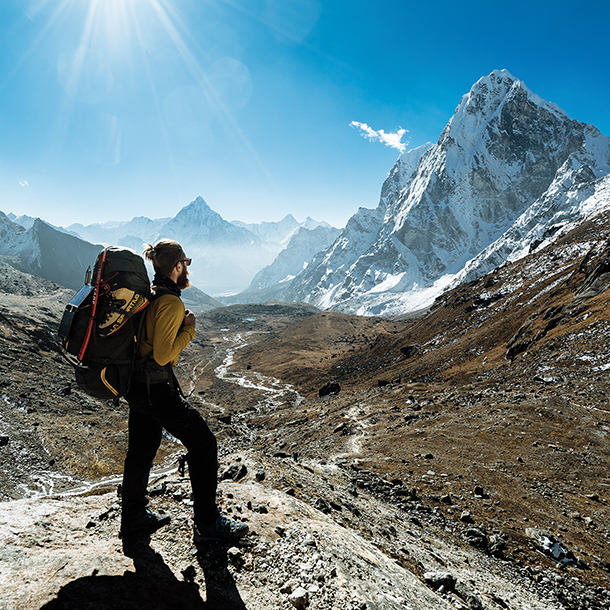 Hiker wearing climbing gear standing on top of Ima Tse mountain